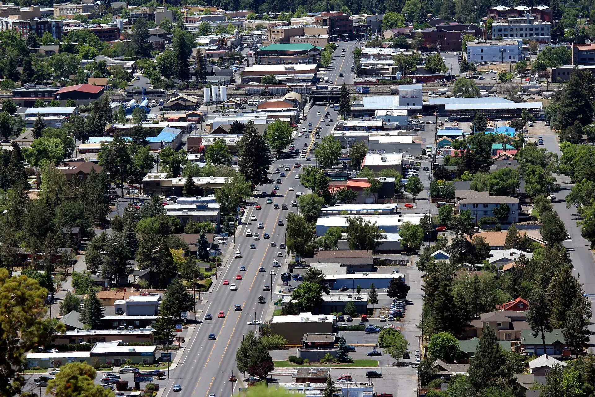 Aerial view of Bend, Oregon from Pilot Butte, showing low-rise commercial buildings and ponderosa pines